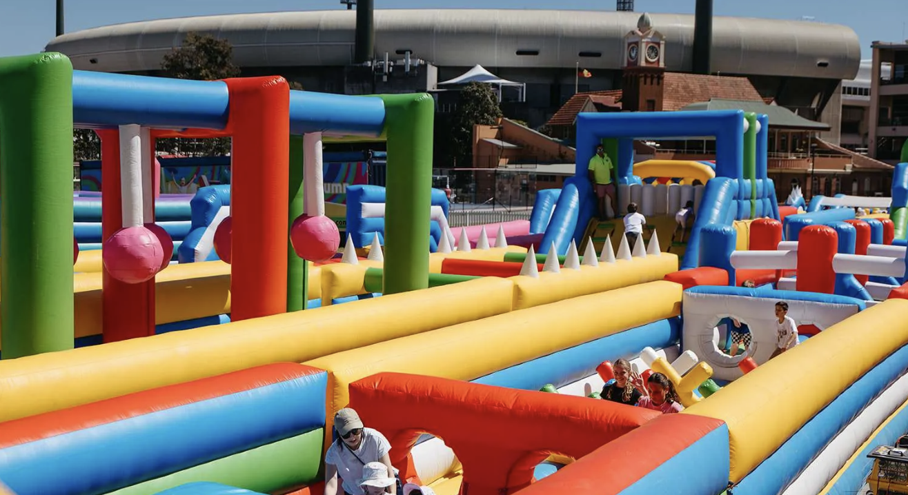 Kids on a giant inflatable obstacle course at Monster Jump Entertainment Quarter