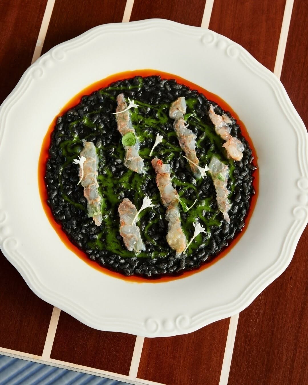 Dark risotto dish served at Riva Rose Bay