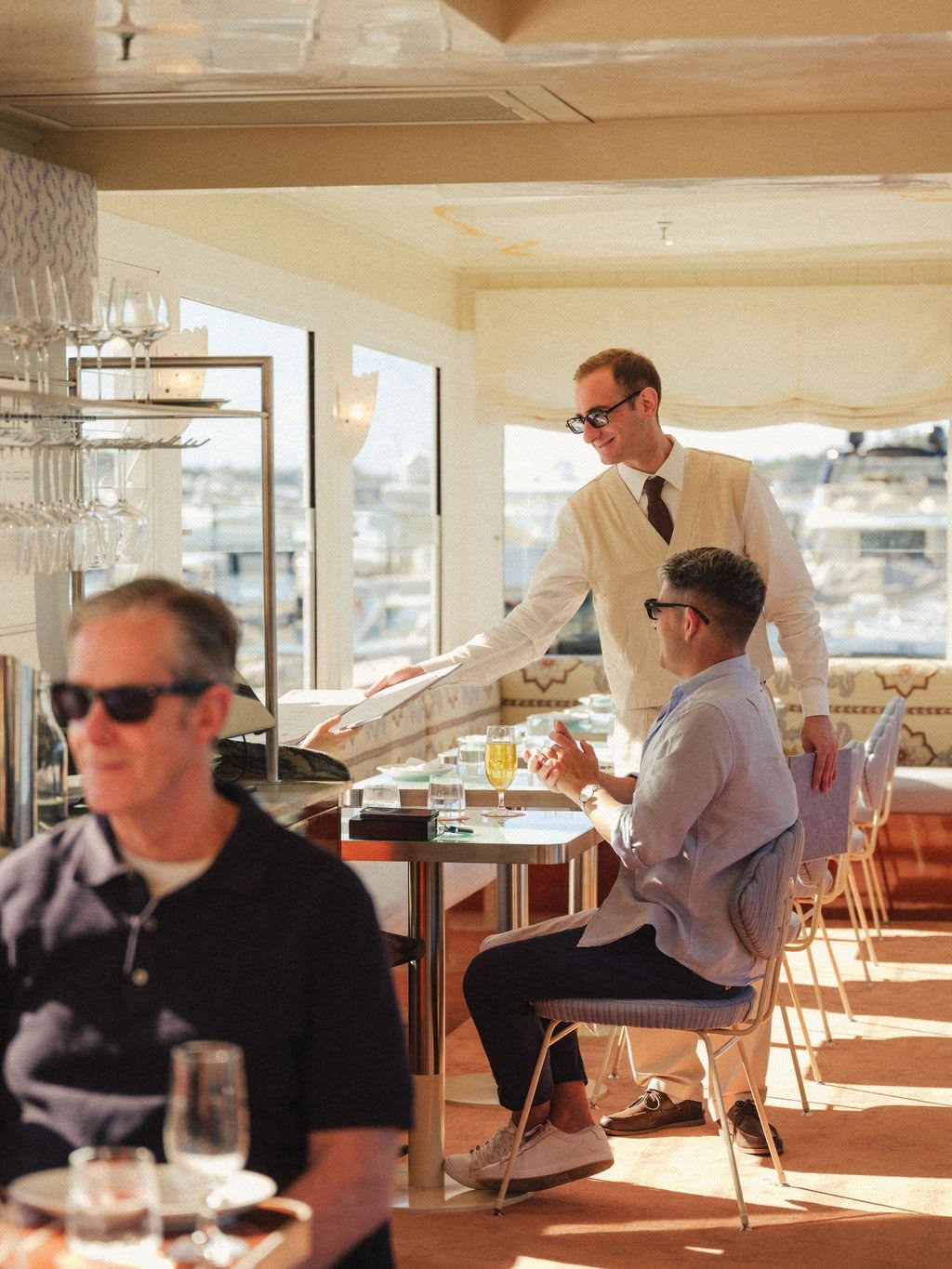 Guests dining beside the marina at Riva Rose Bay