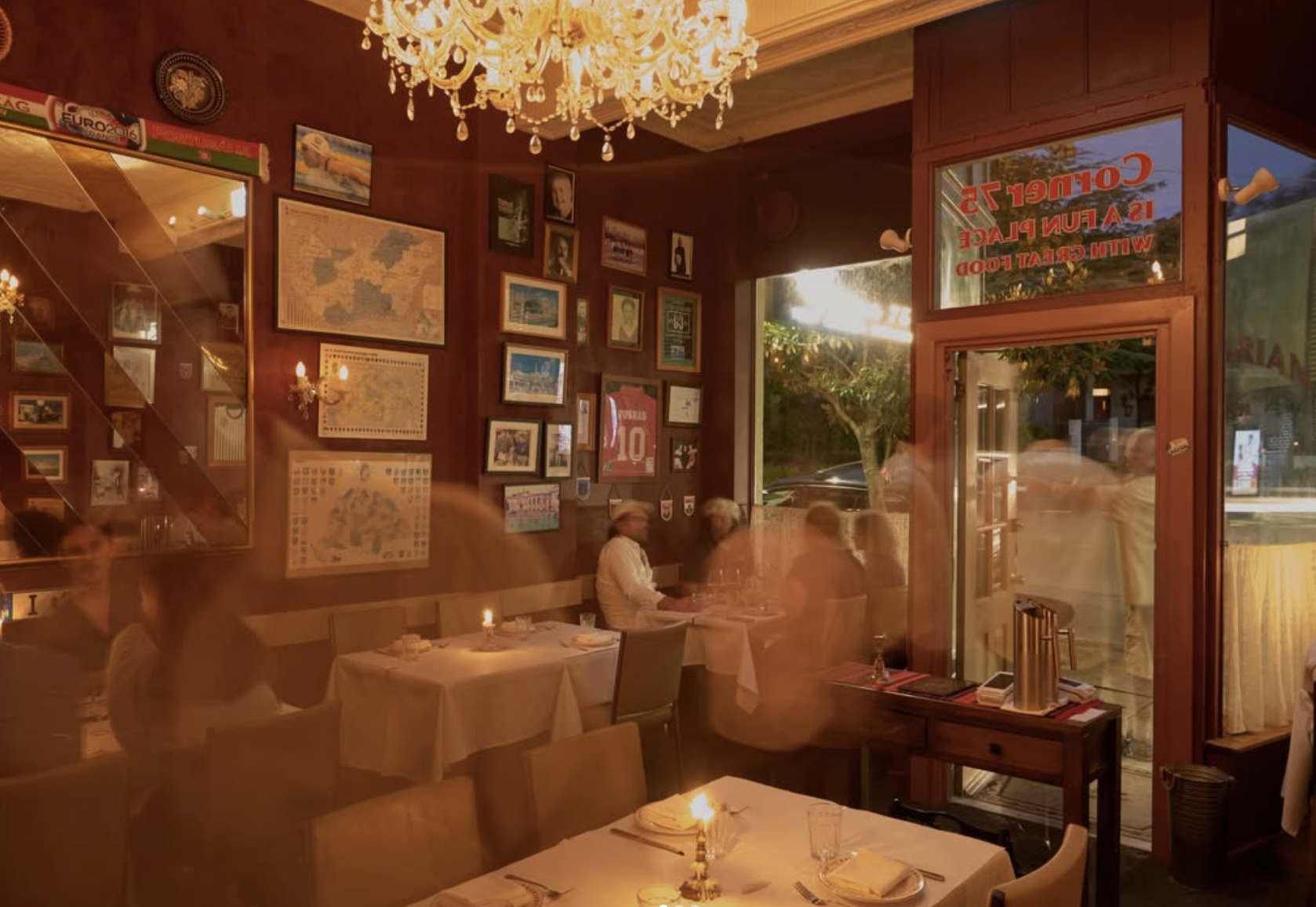 The chandelier-lit dining room inside Corner 75 in Randwick