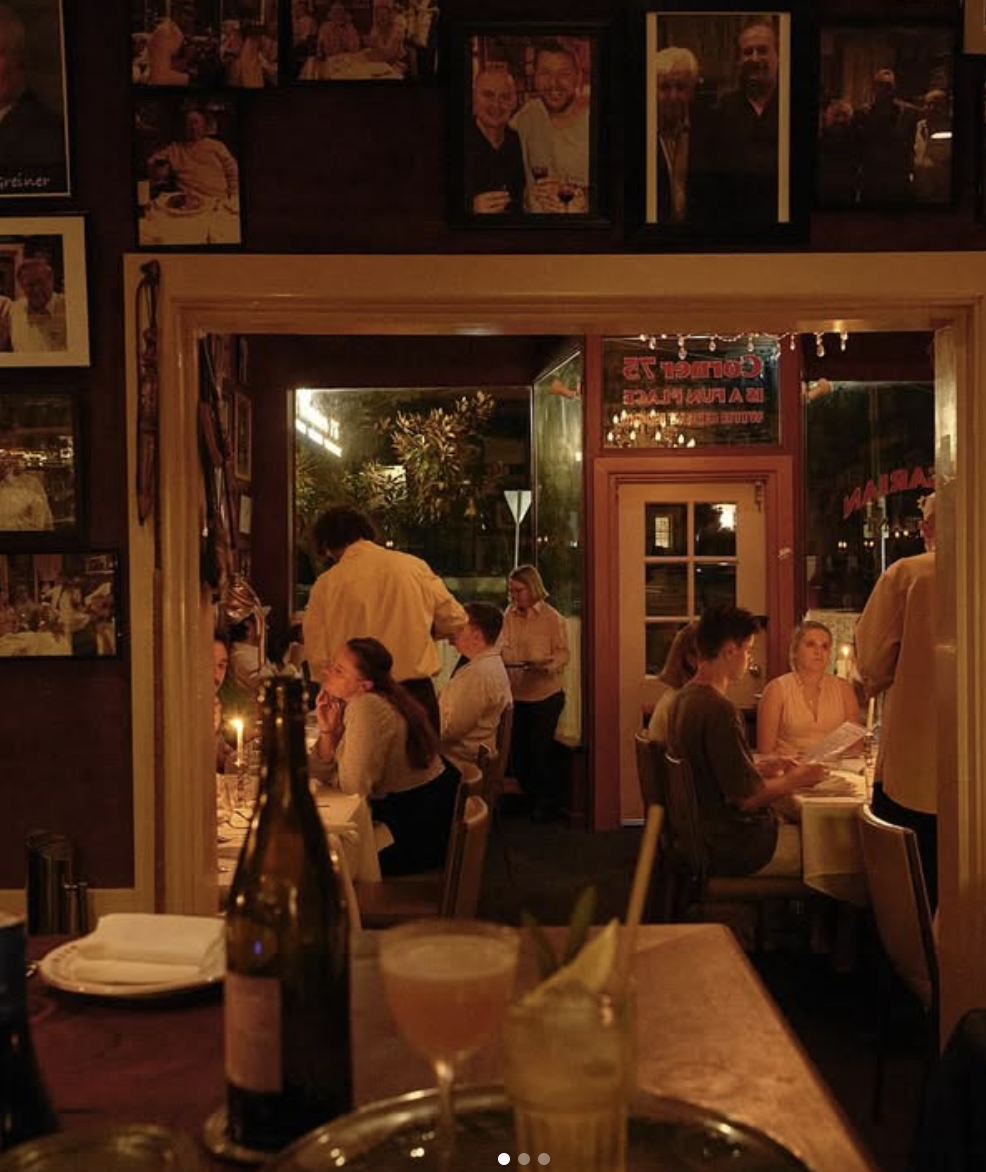 The warm candlelit dining room at Corner 75 in Randwick